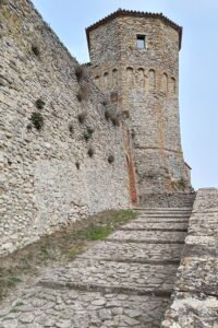 Stone towers and walls of Montebello Castle at Poggio Torriana, home of the Azzurrina legend